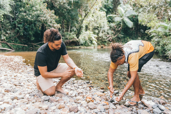 juan, the walkabout cultural adventures owner and guide showing a guest a local river